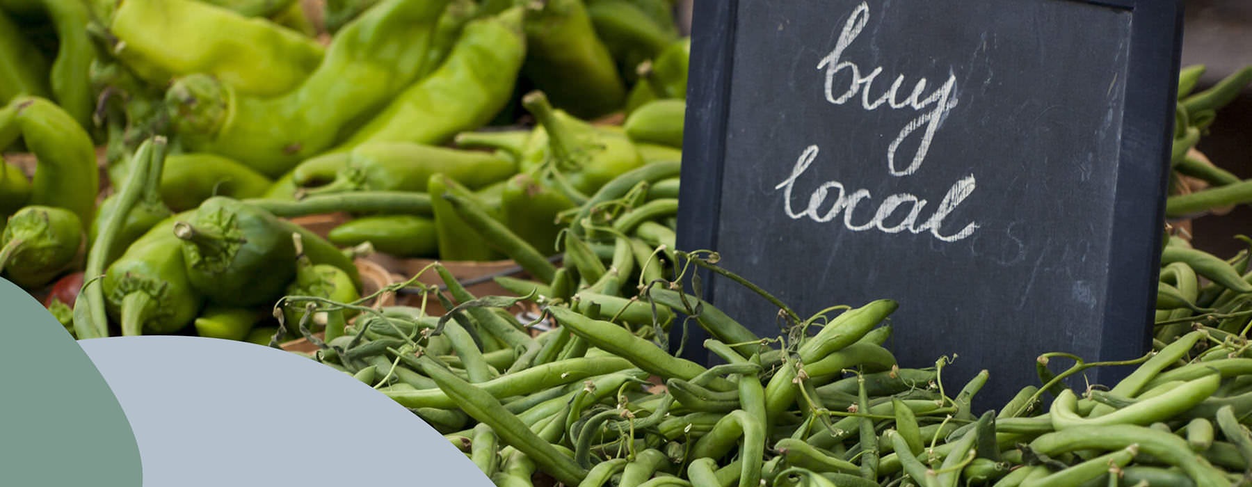 Green Beans And Chilis At Farmer's Market By Chalkbaord Sign That Reads "Buy Local"
